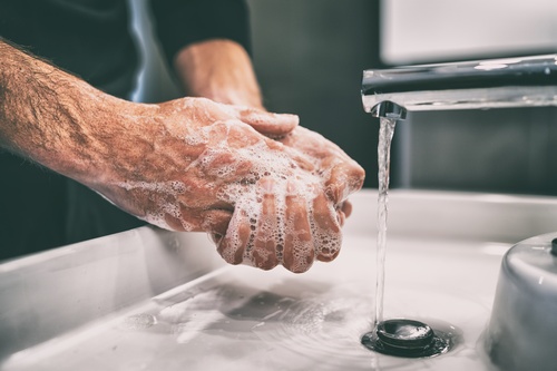 A man washing his hands with soap.