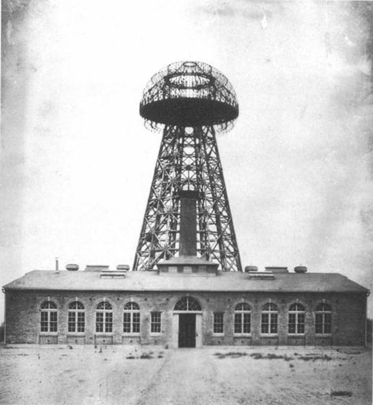 A black and white photo of an electricity tower