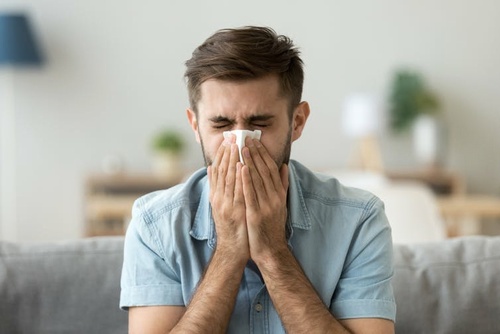 A man with COVID sneezing A man with COVID sneezing